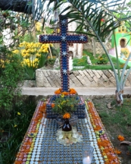 a religious theme for a headstone made with beer bottle caps and quart of corona beer