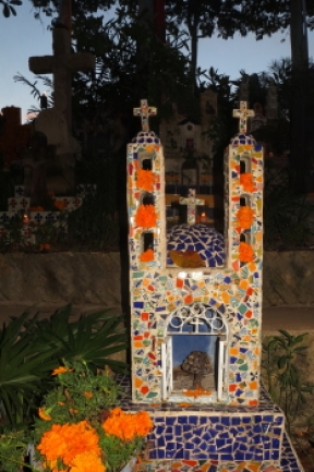 a tiled headstone with other religious design elements