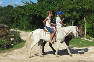 Horseback riders leaving the stables and heading to the jungle trails