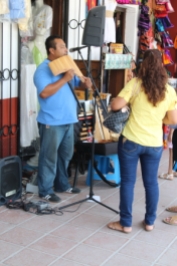 a street muscian entertaining shoppers in the main plaza