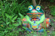 a ceramic frog placed along the LCS garden pathway