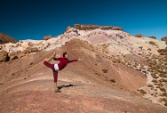 a yoga instructor from Buenos Aires practices her art forms with the hill of 7 colores in the background